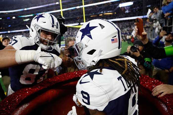 Nov 23, 2023; Arlington, Texas, USA; Dallas Cowboys wide receiver KaVontae Turpin (9) eats a turkey leg as tight end Jake Ferguson (87) feeds him in the fourth quarter against the Washington Commanders at AT&T Stadium. Mandatory Credit: Tim Heitman-USA TODAY Sports